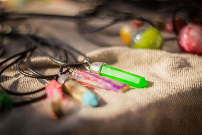 Close-up of multi colored pendulums on tablecloth 