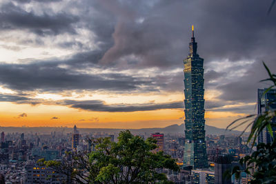 Buildings against cloudy sky during sunset