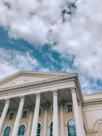 Low angle view of building against cloudy sky