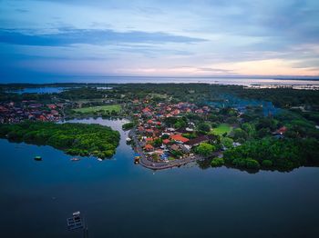 High angle view of cityscape by sea against sky