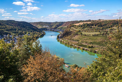 High angle view of river amidst trees against sky