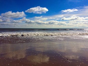 Scenic view of sea against cloudy sky