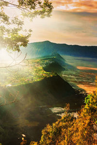 Scenic view of landscape and mountains against sky during sunset