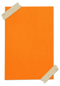 Close-up of orange paper against white background