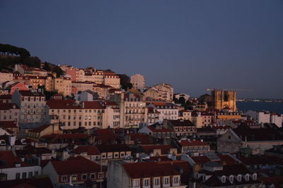 Houses in town against clear sky