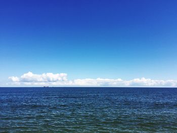 Scenic view of sea against blue sky