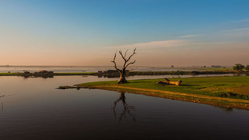 Scenic view of lake against sky during sunset