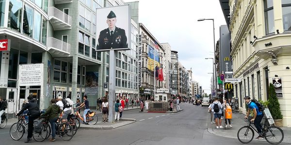 People on street amidst buildings in city