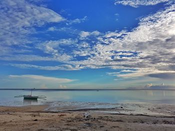 Scenic view of sea against blue sky