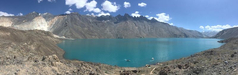 Panoramic view of lake and mountains against blue sky