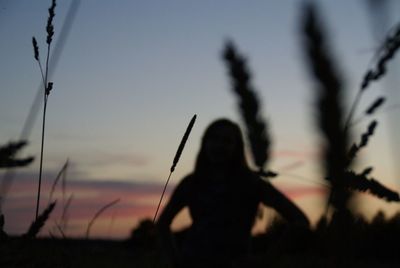 Close-up of silhouette person against sky during sunset