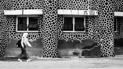 Full length of man standing outside building