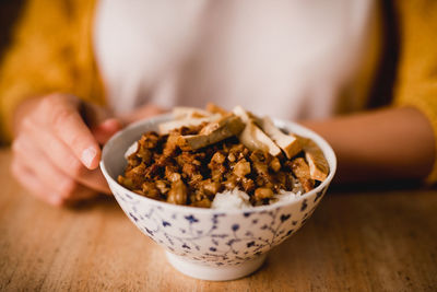 Close-up of woman holding ice cream in bowl