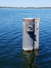 Wooden posts in sea