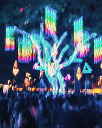 Group of people in amusement park at night