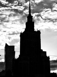 Low angle view of buildings against cloudy sky