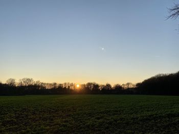 Scenic view of field against sky during sunset