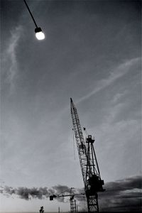 Low angle view of crane against sky