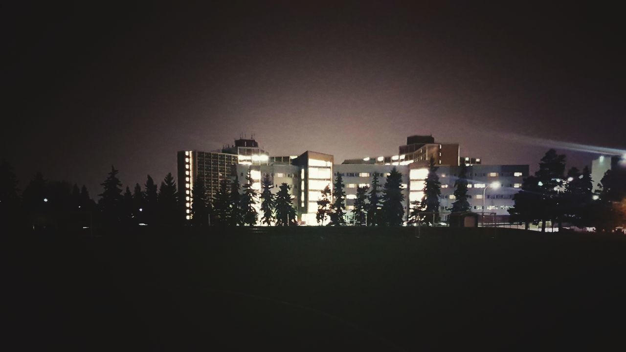 SILHOUETTE BUILDINGS AGAINST SKY DURING NIGHT