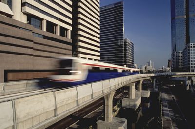 Blurred image of metro train moving on track in city