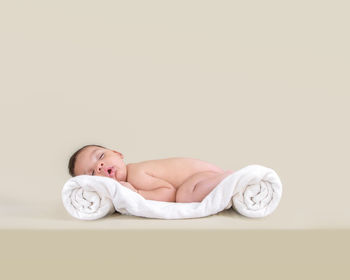 High angle view of baby boy lying on table