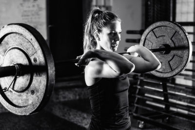 Cross training. female athlete lifting weights