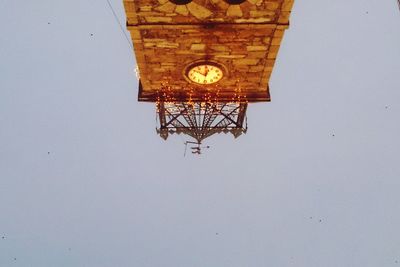 Low angle view of clock tower against clear sky