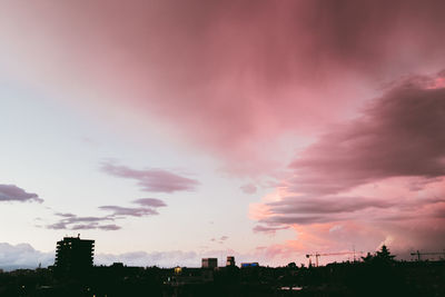 View of cityscape against dramatic sky