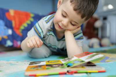 Boy drawing on book