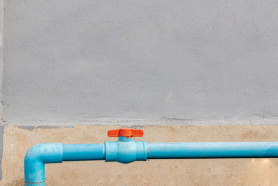 Close-up of blue pipe on wall