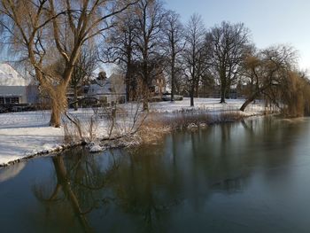 Scenic view of frozen lake against sky during winter