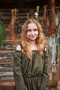 Portrait of smiling girl standing against plants