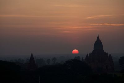 Historic temple against sky during sunset