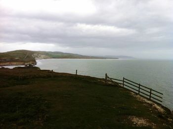 Scenic view of landscape against cloudy sky