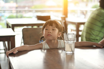 Portrait of a girl sitting on table