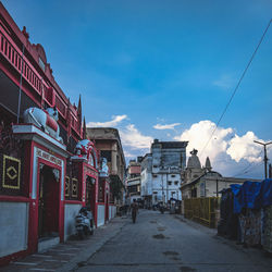 Street amidst buildings against sky in city