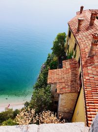 High angle view of houses by sea against sky