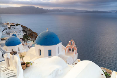 Panoramic view of sea and buildings against sky