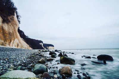 Rocks on beach against sky