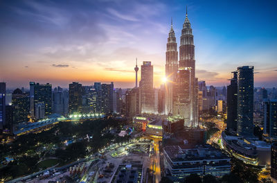 Illuminated cityscape against sky at night