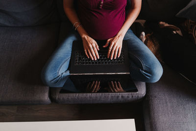 Midsection of woman using mobile phone