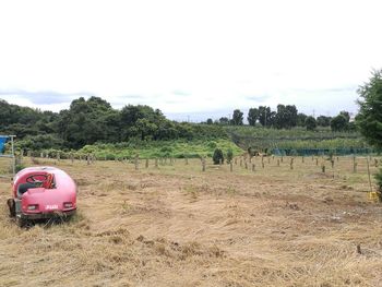 Tractor on field against sky