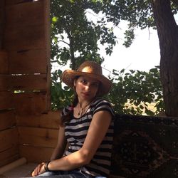 Portrait of woman sitting in tree house