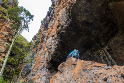  a hiker inside a cave at mau mau caves in chogoria route, mount kenya national park, kenya