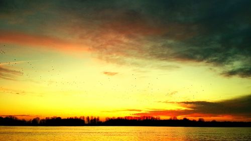 Scenic view of lake against sky during sunset