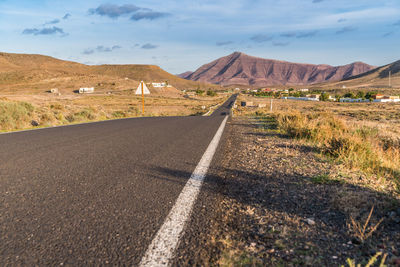 Road amidst landscape against sky