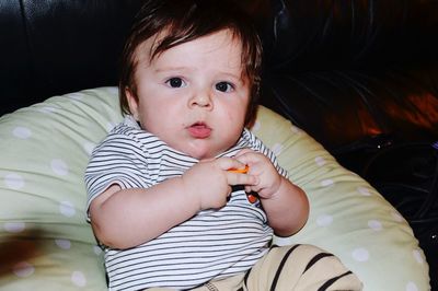 Portrait of cute baby lying on bed