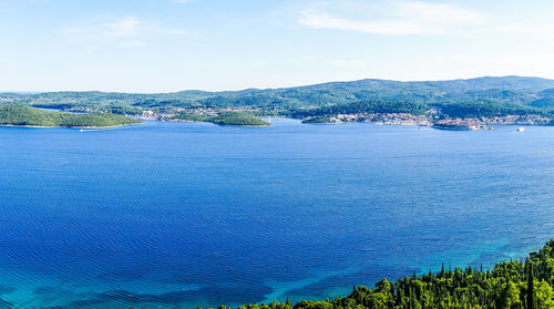 Scenic view of cityscape against blue sky