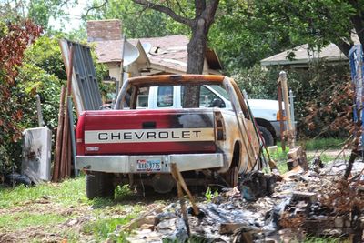 View of abandoned car on field