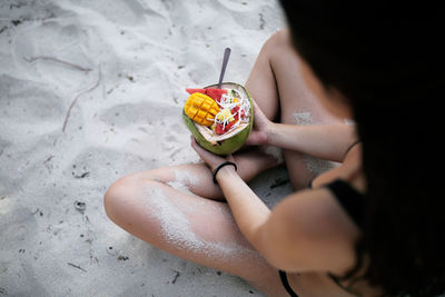 High angle view of woman holding ice cream on land